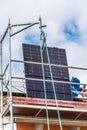 Lifting solar panels using pulley. Installing solar panels on a roof. Solar panels on roof