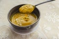 Lifting Thick Pumpkin Soup From A Bowl