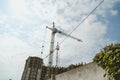 Lifting tower cranes on frame of frame building Royalty Free Stock Photo