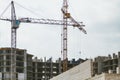 Lifting tower cranes on frame of frame building Royalty Free Stock Photo