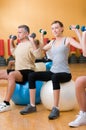 Lifting weigths on a fitness ball Royalty Free Stock Photo