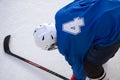 Lifts the hockey player shoots the puck and attacks stick .