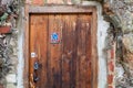 Old weathered wooden door with a funny blue elephant sticker