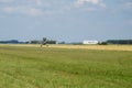 Light aircraft. Light silver airplane lands in airport. Sunny summer day and blue sky Royalty Free Stock Photo