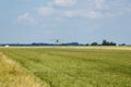 Light aircraft. Light silver airplane lands on airport. Sunny summer day and blue sky Royalty Free Stock Photo