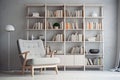 light armchair near a large bookcase on gray wall background in living room Royalty Free Stock Photo