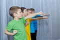 On a light background, boys in multi-colored T-shirts make a punch