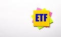 On a light background - bright multicolored stickers with the text ETF Exchange Traded Funds. Copy space Royalty Free Stock Photo