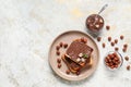Plate of bread with chocolate paste and hazelnuts on light background Royalty Free Stock Photo