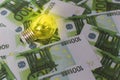 Light on the background of Euro money, expensive electricity Royalty Free Stock Photo