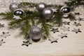 a spruce branch, silver balls and stars
