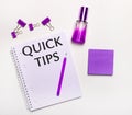 On a light background - a lilac gift, perfume, lilac business accessories and a notebook with a lilac inscription QUICK TIPS. Flat