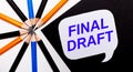 On a light background, multi-colored pencils and on a black background a white card with the text FINAL DRAFT Royalty Free Stock Photo