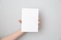 Female hand with blank invitation card on light background