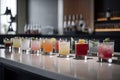 Light bar counter with colorful cocktails in old fashion glasses. Generative AI Royalty Free Stock Photo