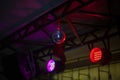 Light in bar. Lighting equipment at party. Spotlight is red. Disco ball on ceiling. Purple glow