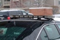 Light bar mounted on the wet roof of a parked black police car on a rainy day Royalty Free Stock Photo