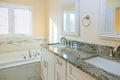 Light bathroom with bathtub and countertop faucet Royalty Free Stock Photo