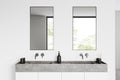 Light bathroom interior with sink and two mirrors, window Royalty Free Stock Photo