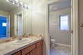 Light bathroom interior with tiled top vanity cabinet