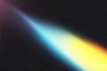 Light beam creating colorful spectrum on dark background