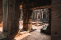 Light beams shine sharply into the the entryway of these ancient cambodian ruins