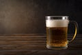 Light beer, beer mug with foam on a dark wooden background, alcoholic beverage Royalty Free Stock Photo