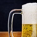Light Beer in a glass pint mug served on a wooden Royalty Free Stock Photo
