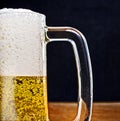 Light Beer in a glass pint mug served on a wooden Royalty Free Stock Photo