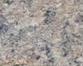 Light beige granite, polished surface of natural stone interspersed with black. Background, Close up shot Royalty Free Stock Photo