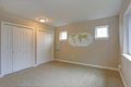 Light beige room interior with white closet doors.