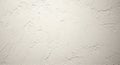Light beige textured plaster wall with irregular patterns. The surface displays a mix of Royalty Free Stock Photo
