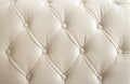 Light beige velour textile diamond pattern with buttons.