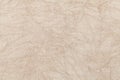 Light beige wavy background from a textile material. Fabric with natural texture closeup.