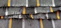 Light black-gray folded fabric with orange and dark blue stripes. Ripped, unfinished fabric edge. Interior decoration. Dress