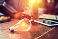 Light blub on the table and blur business working back Royalty Free Stock Photo