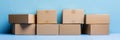 A light blue background with Amazon cardboard boxes piled up Royalty Free Stock Photo