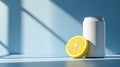 A light blue background features a blank white soda can and a lemon slice Royalty Free Stock Photo
