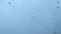 Light blue background of wet glass with dripping droplets and copy space Royalty Free Stock Photo