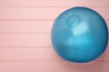 Light blue beach ball on pink wooden background, top view. Space for text Royalty Free Stock Photo