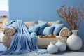 Light blue and beige interior with sofa, blanket and pillow at the blue wall. Copy space Royalty Free Stock Photo