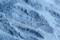 Light blue bentonite facial clay powder alginate mask, body wrap texture close up, selective focus. Abstract background