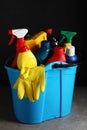 Light blue bucket with car cleaning products on grey table Royalty Free Stock Photo