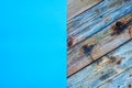 Light blue cardstock on a rustic table constructed from aged wooden planks. Abstract background Royalty Free Stock Photo