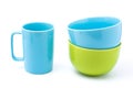 Light blue coffee cup and light blue bowl and green bowl