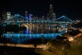 Light blue coloured Story bridge, cantilever bridge with Brisbane city illuminated beyond Royalty Free Stock Photo