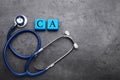 Light blue cubes with symbol Ca (Calcium) and stethoscope on black background, top view Royalty Free Stock Photo