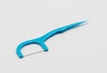 Light blue dental floss pick with flat thread and wide bow for d