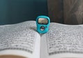 a digital rosary and a Quran on the table Royalty Free Stock Photo