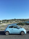 Blue Fiat 500 lifestyle at coast